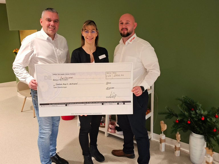 Pflegedienstleitung Stefanie Micklitza (Mitte) erhält Spendenscheck von Autoland